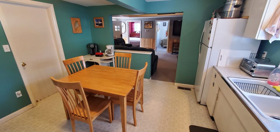 View of kitchen and family room from the main entrance. 
