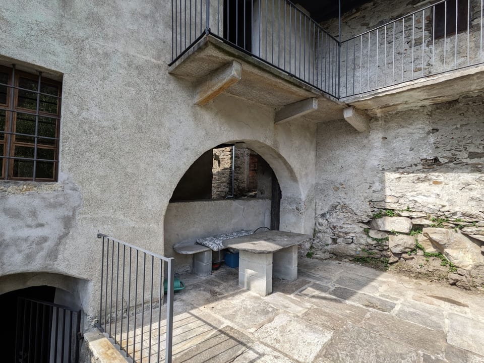 Outdoor terrace with stone table and granite paving and panoramic view