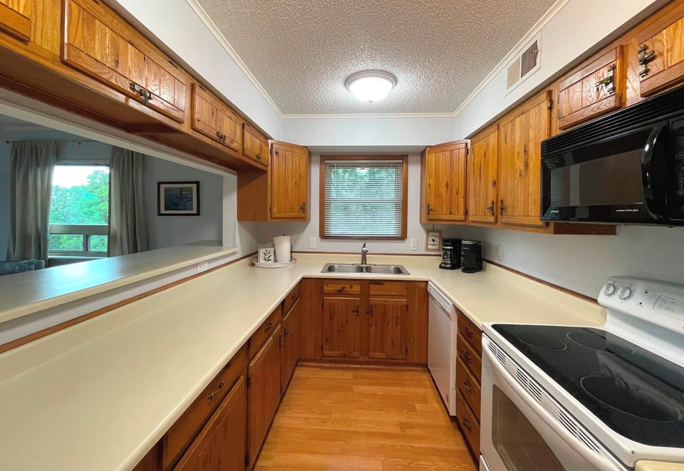 Spacious kitchen with lots of counter space and cabinetry.  Full size appliances.