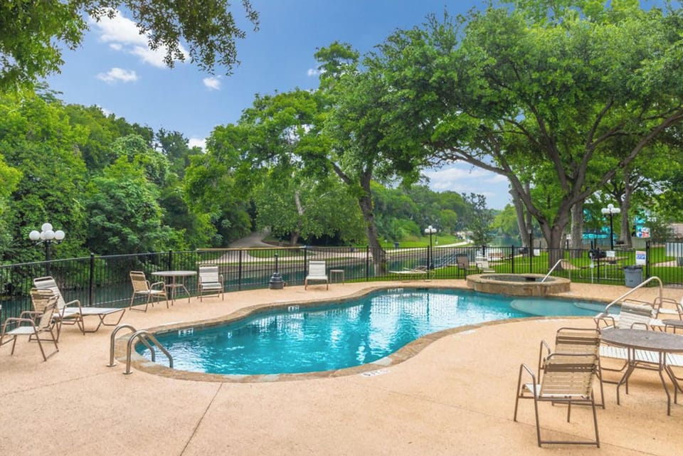Pool and hot tub with view of the Comal River.