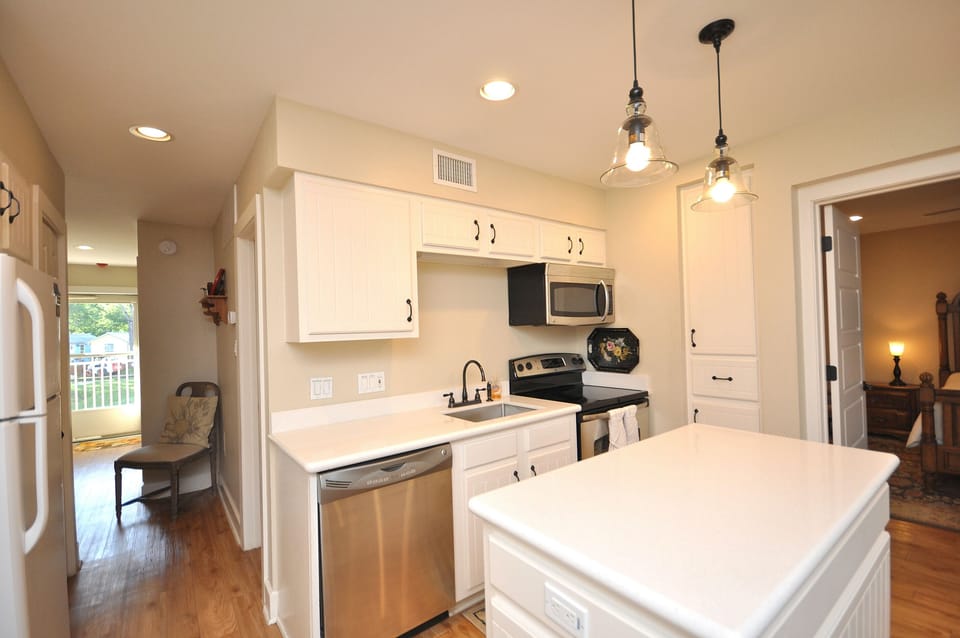Cabinet next to stove and microwave is a small pantry.