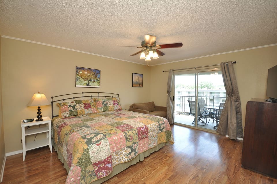 Spacious primary bedroom with access to balcony.