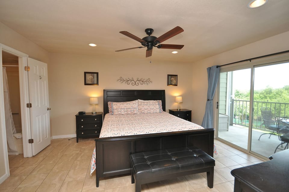 Primary bedroom with access to double balcony.