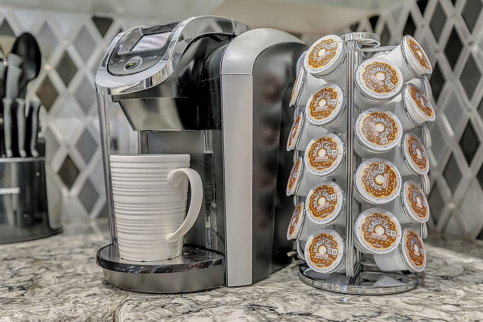 Keurig with complimentary (limited) supply of K-cups, sweetener, and creamer. Yum! Stocked in Every Home.