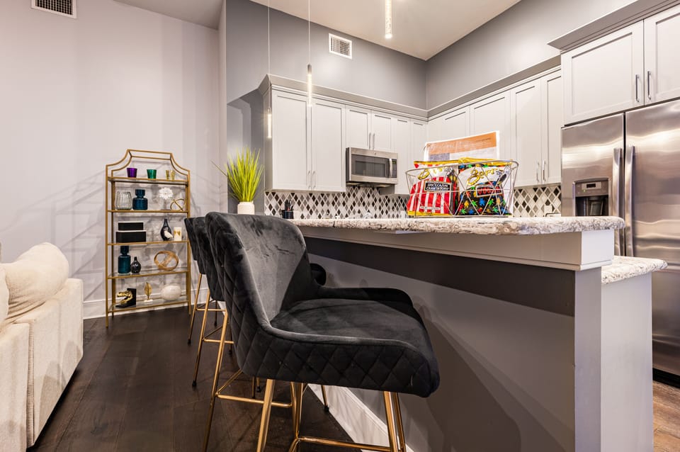 Cook and dine easily in the fully stocked kitchen, equipped with all stainless steel appliances, gas range, basic cookware, and a dining area for a comfortable meal at home. Entertain at the bar with seating for four.
