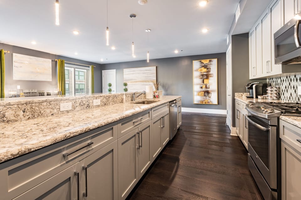 Cook and dine easily in the fully stocked kitchen, equipped with all stainless steel appliances, gas range, basic cookware, and a dining area for a comfortable meal at home. Entertain at the island with seating for four.