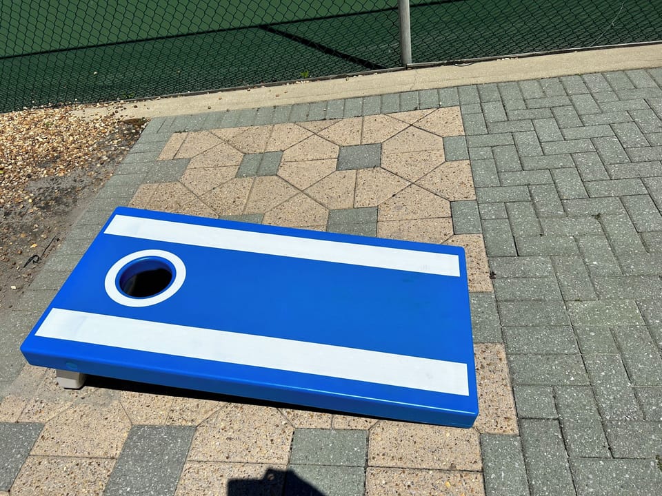 Cornhole available near the pickleball courts.