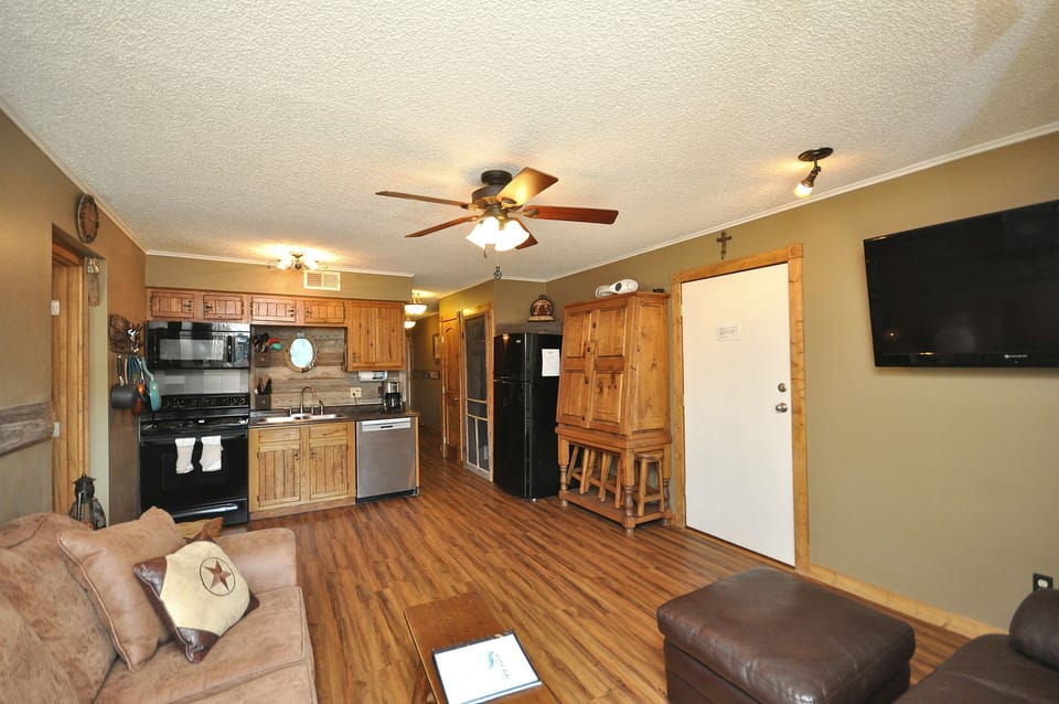 Kitchen opens to living and dining areas.