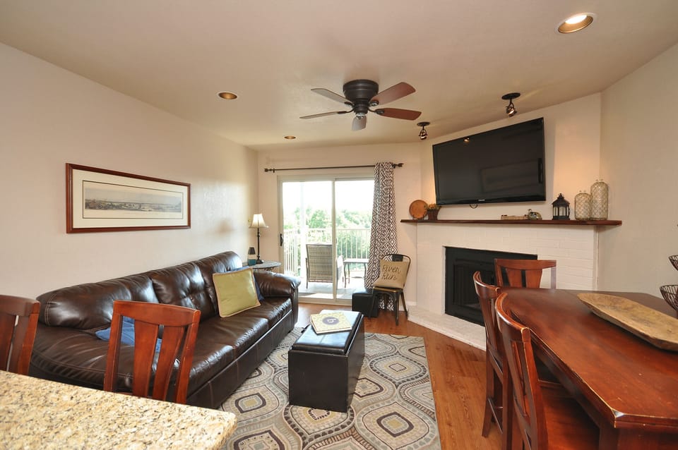 Flat screen TV can be seen from kitchen and living area.