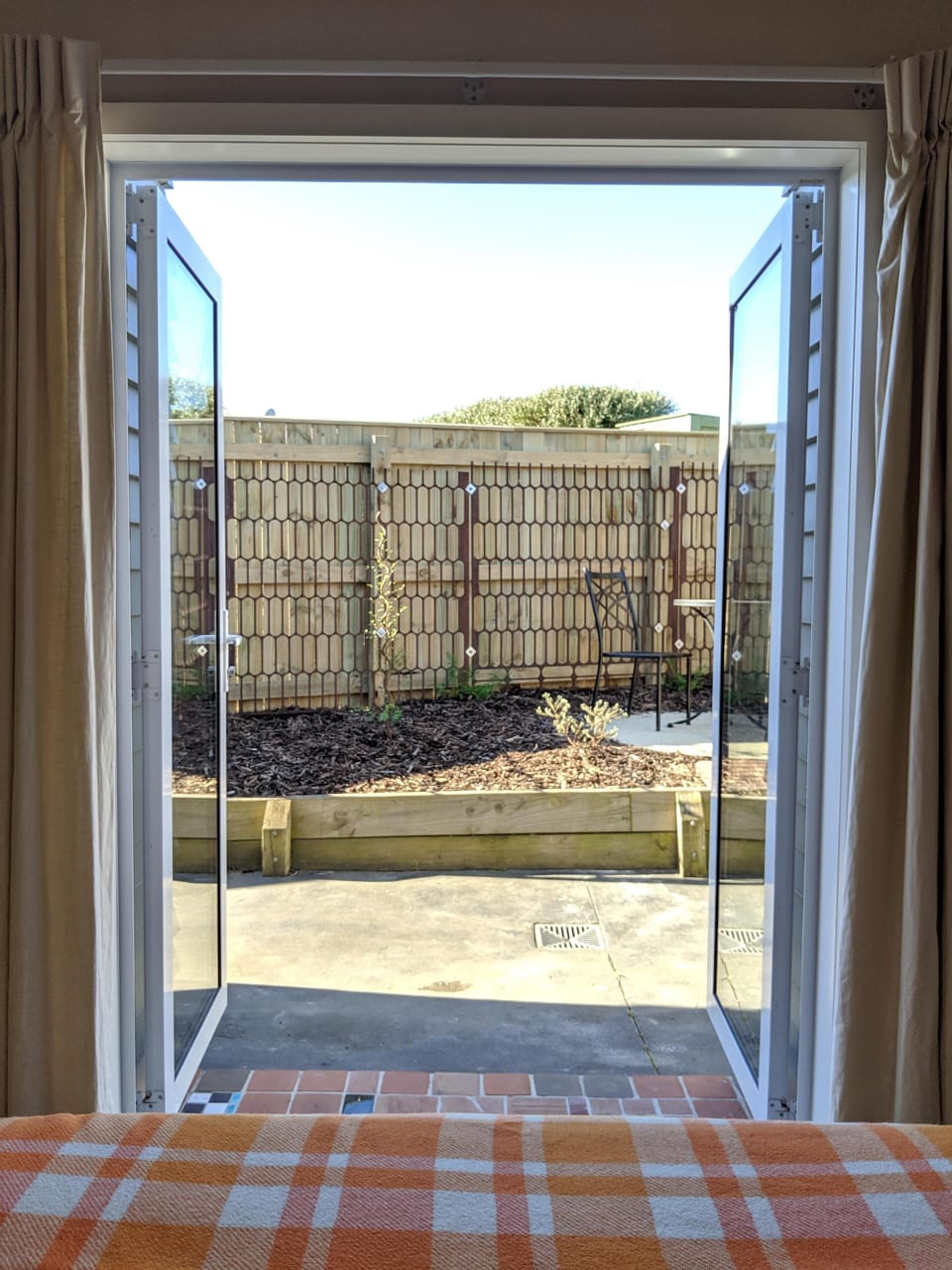 View from bedroom to rear outdoor seating area