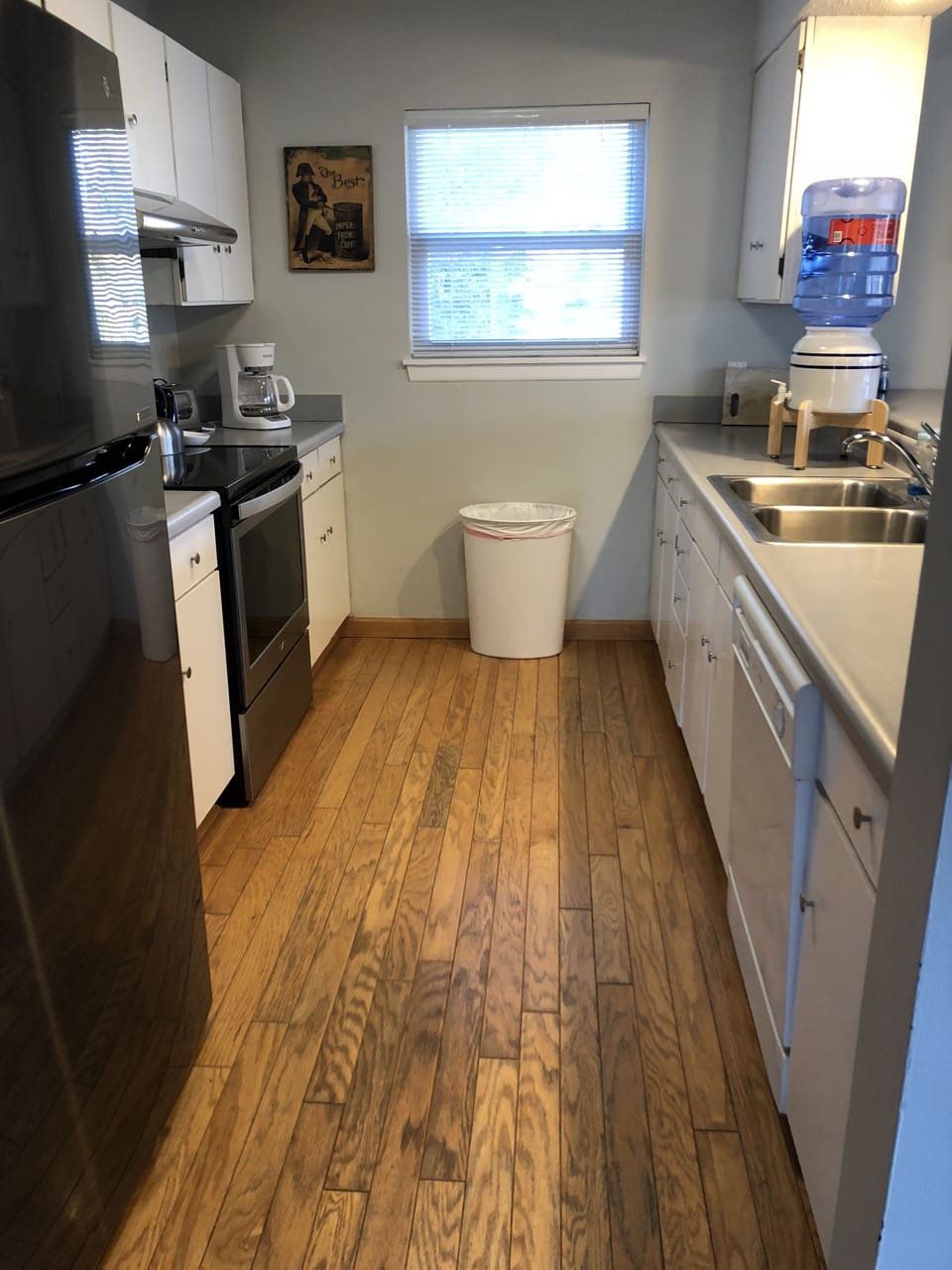 Galley Kitchen with new refrigerator and stove.