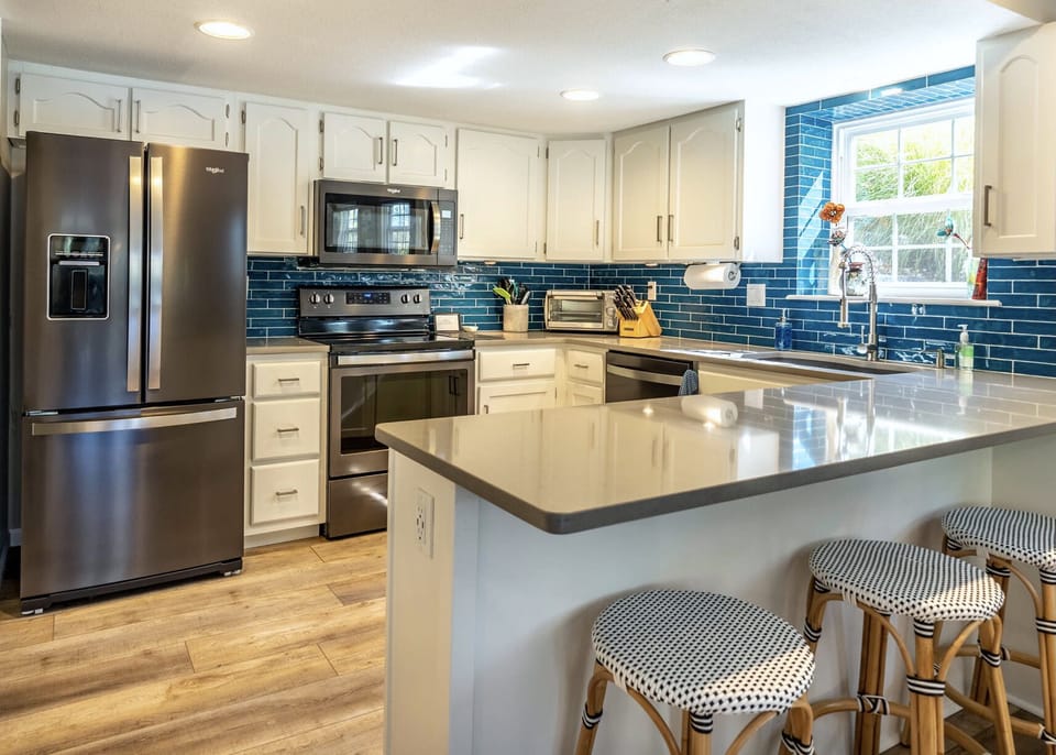 Updated kitchen w/ cooking basics, new appliances, and bar seating