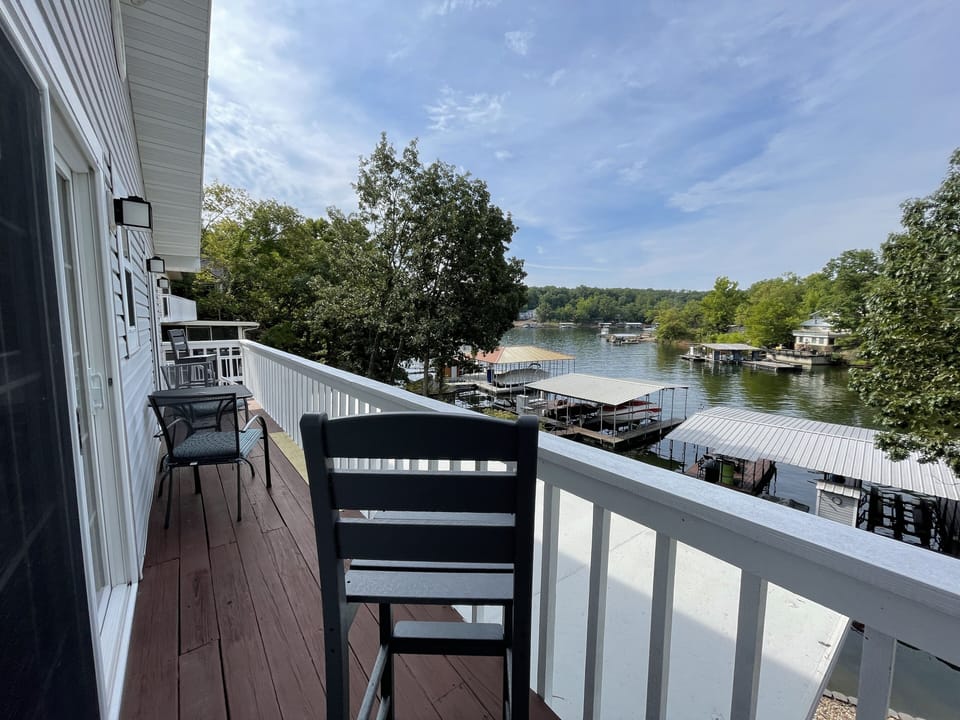 Shared balcony from primary BR to bed #2. Enjoy 2 barstools, and a bistro table