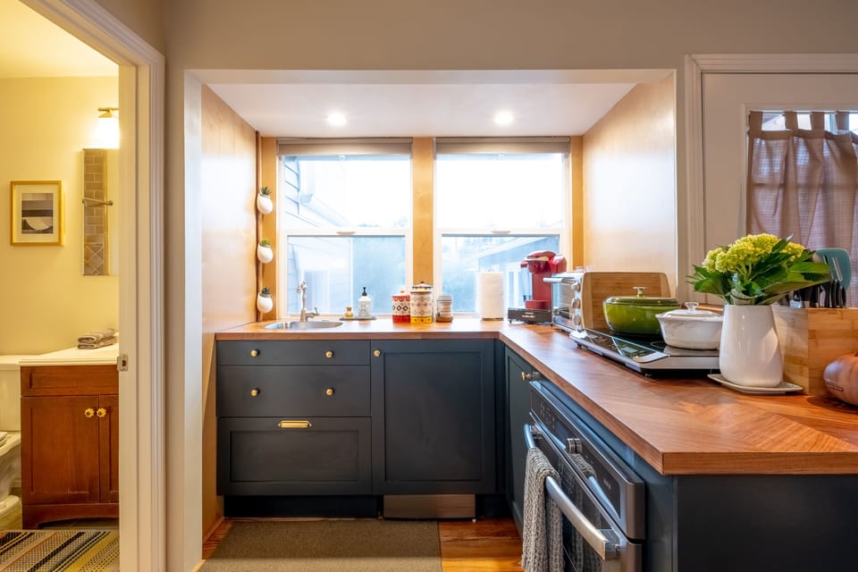Kitchen with GE Advantium oven/microwave combo, refrigerator, and cooktop. 