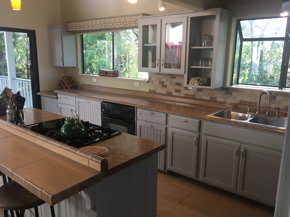 Kitchen with gas stove and barstool seating