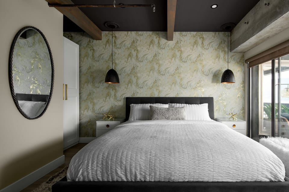 Luxurious king bed with floor to ceiling windows looking out over the lake