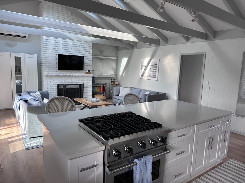 open concept kitchen and living room. Kitchen equipped with Viking oven.