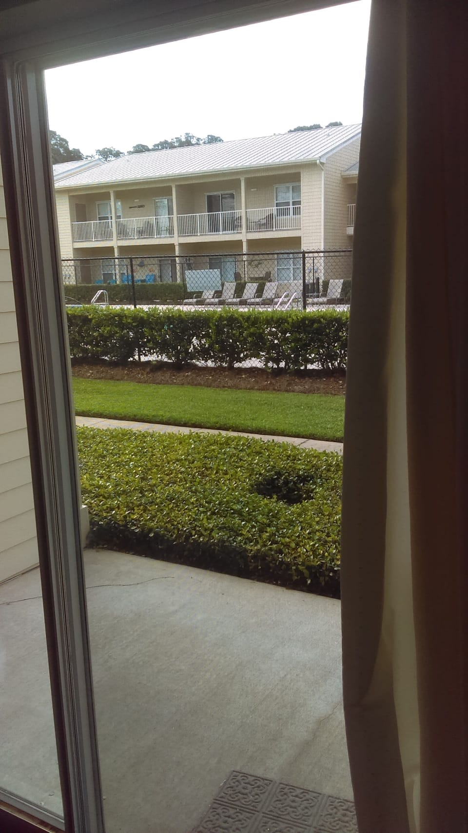 View from Sliding Lanai Door that Overlooks Pool and Courtyard.
