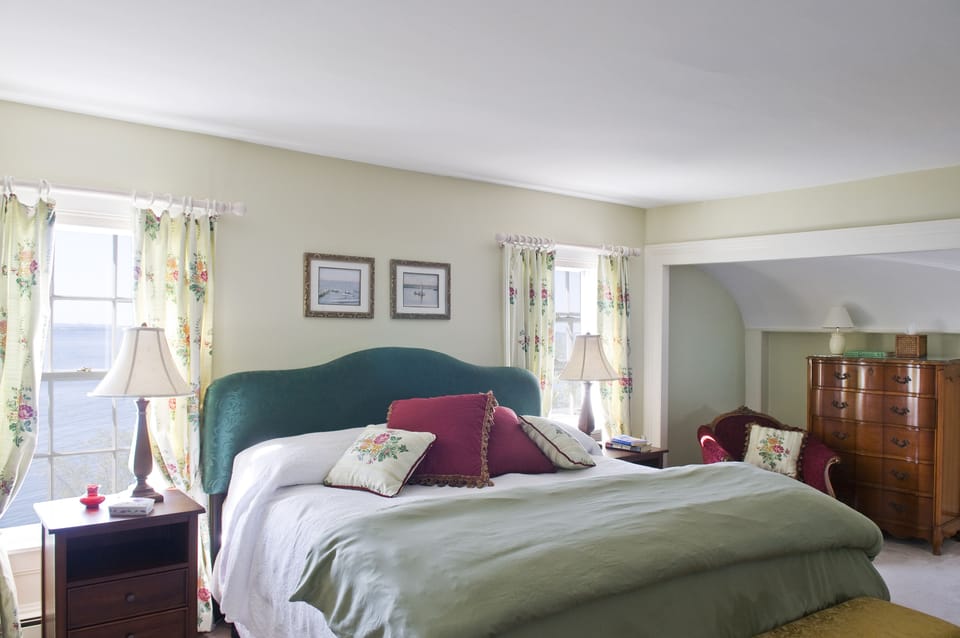 Master bedroom on second floor with king bed. Looking west. Views of lake.