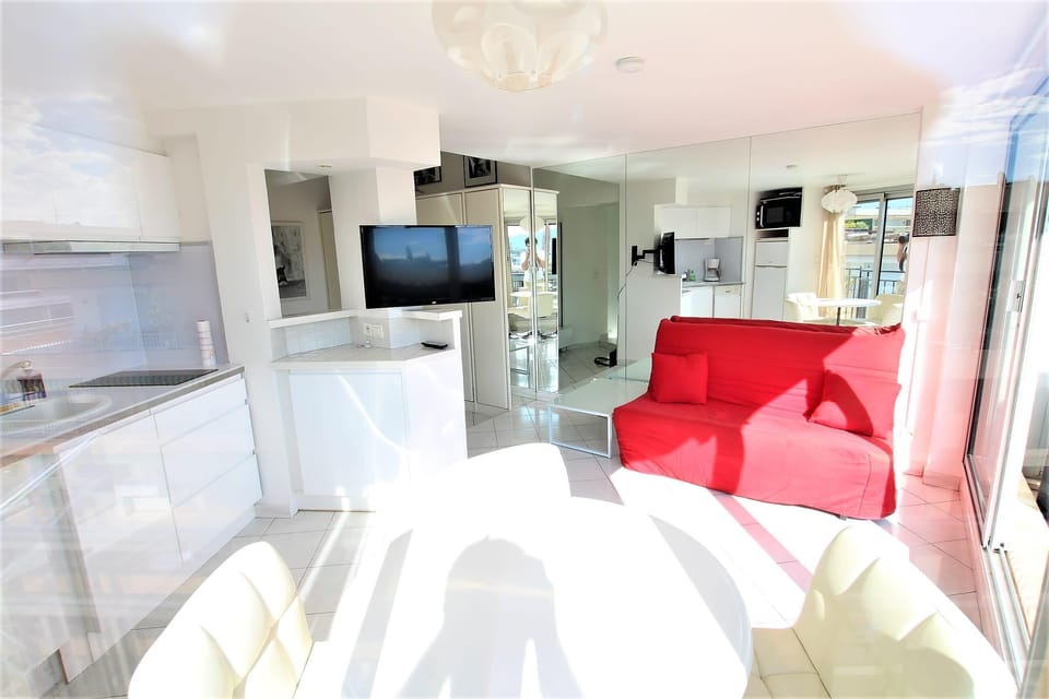 living room with lounge area, dining table and removable TV 