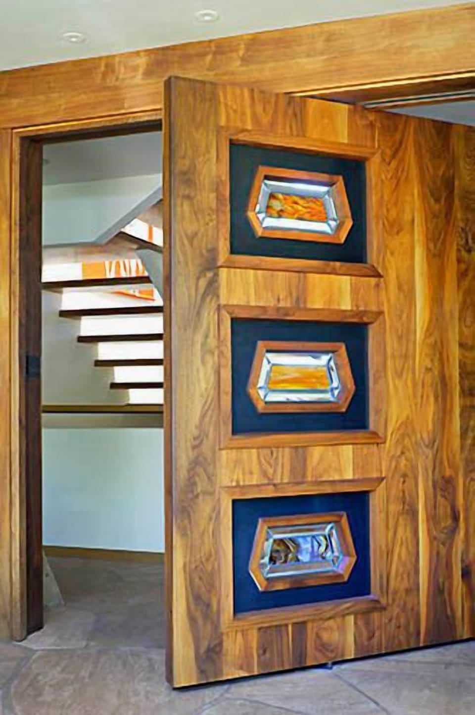 Custom pivoting black walnut front door