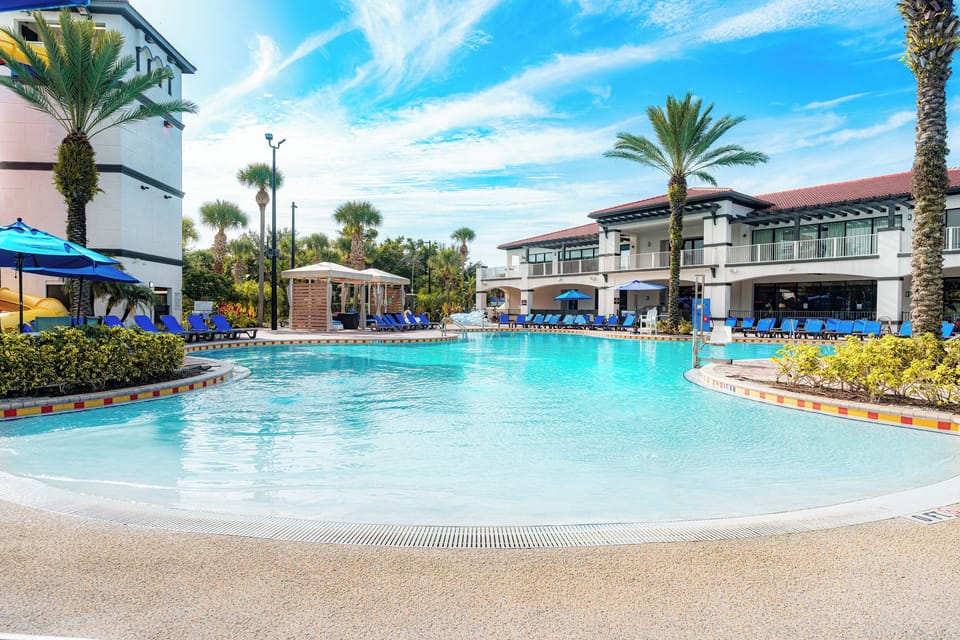 Dive into a sprawling lagoon pool framed by palms.