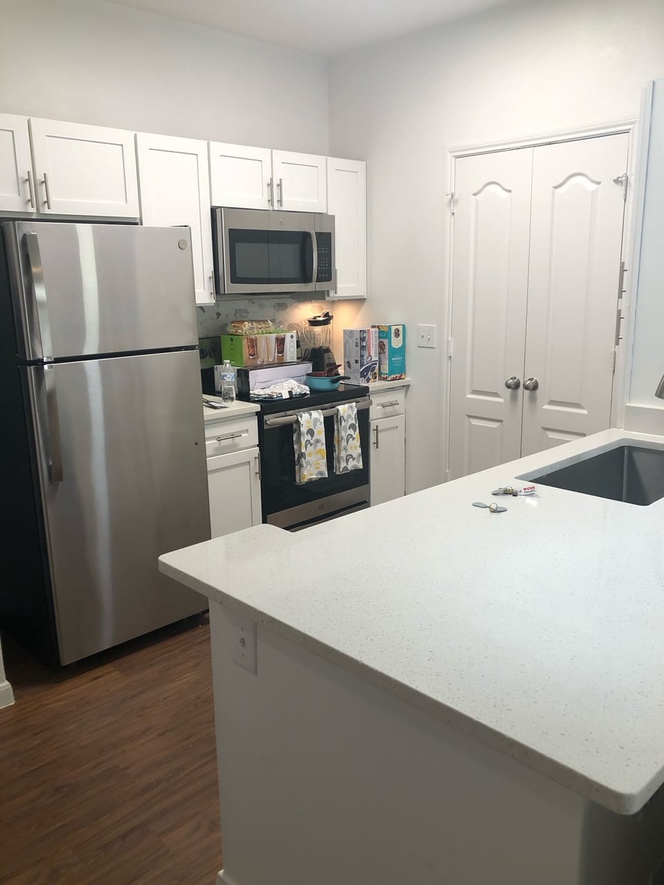 Kitchen island and  laundry room behind the doors 