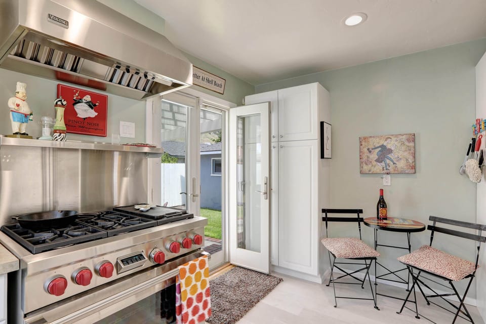 Kitchen has chef grade appliances and a bistro table