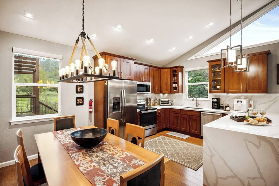 The chandelier over the dining table is a nice touch for dinners that run late — and around here, most of them do. Plenty of counter and prep space for whoever ends up in charge of cooking.