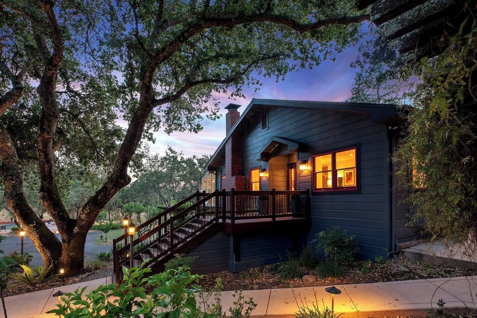 The Main House at golden hour, surrounded by the estate grounds. ~2,000 sq ft inside, 14 acres outside, and your group has it entirely to yourselves.