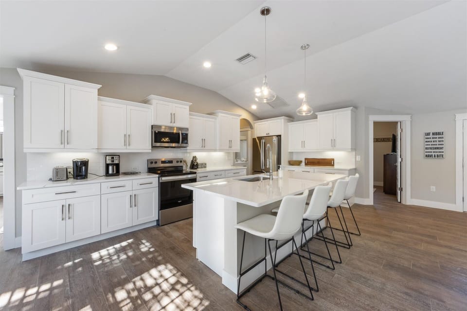 Open concept kitchen is bright with plenty of counter and cabinet space