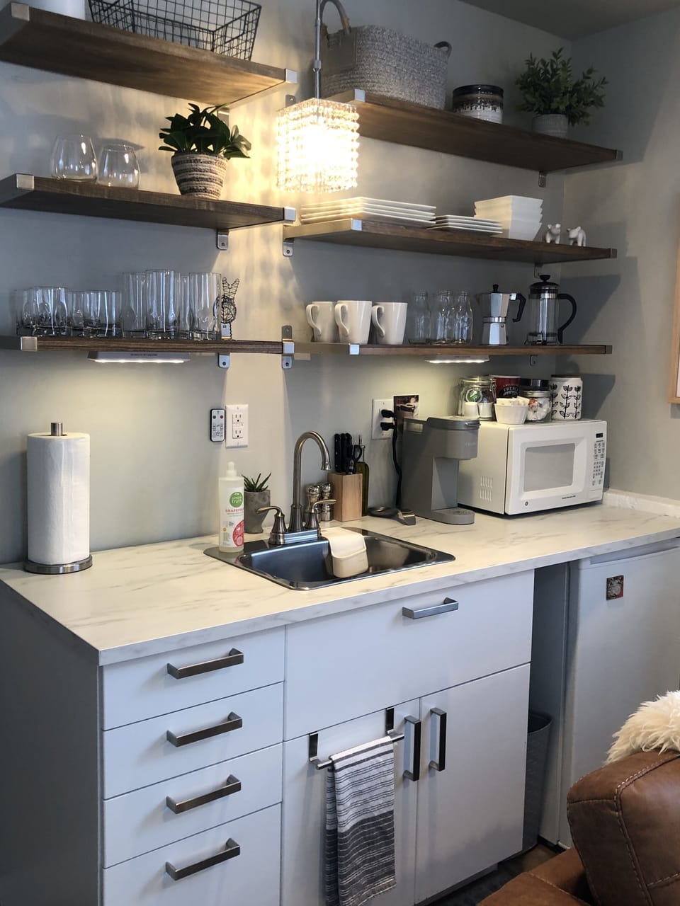 Kitchenette - includes a hot plate, microwave, toaster, and cooking utensils. 