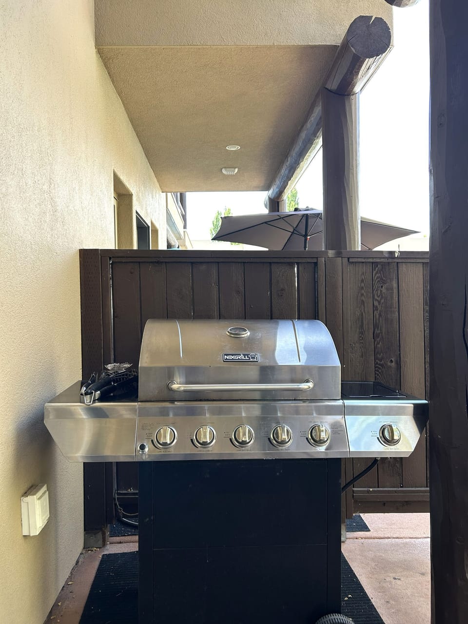 Private Condo Patio with Outdoor Dining Table, Chairs, Umbrella & BBQ
