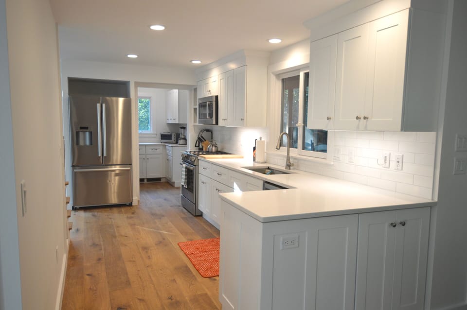 modern, well-equipped kitchen with pantry area beyond