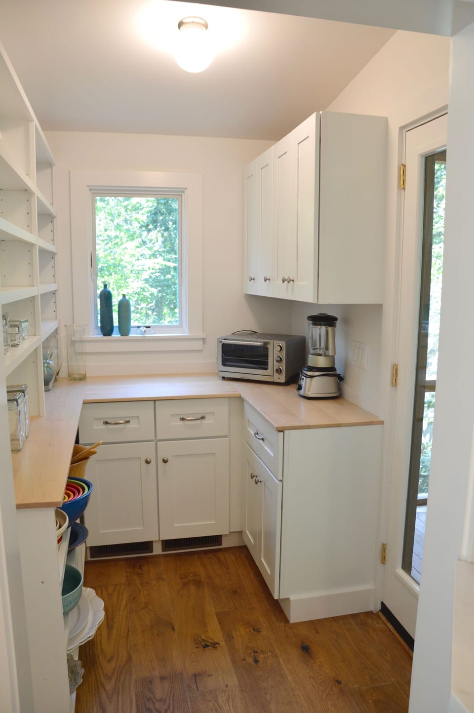 pantry has lots of storage and door leading out to the screened-in porch
