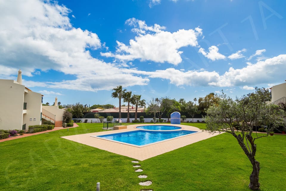 Inviting communal swimming pool surrounded by manicured lawns at the holiday apartment complex near Carvoeiro, Algarve