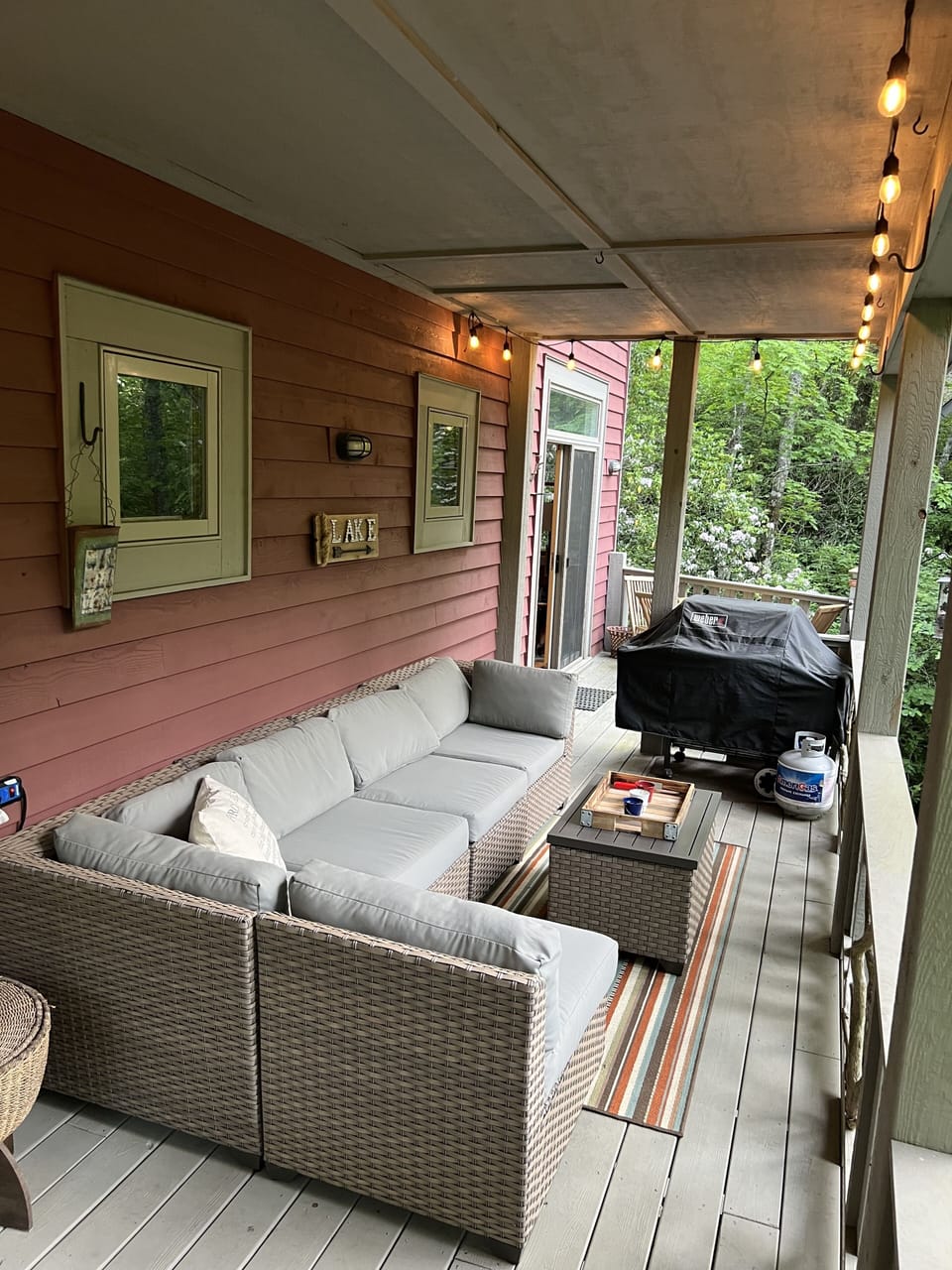 Grill and plenty of seating; table set beyond grill
