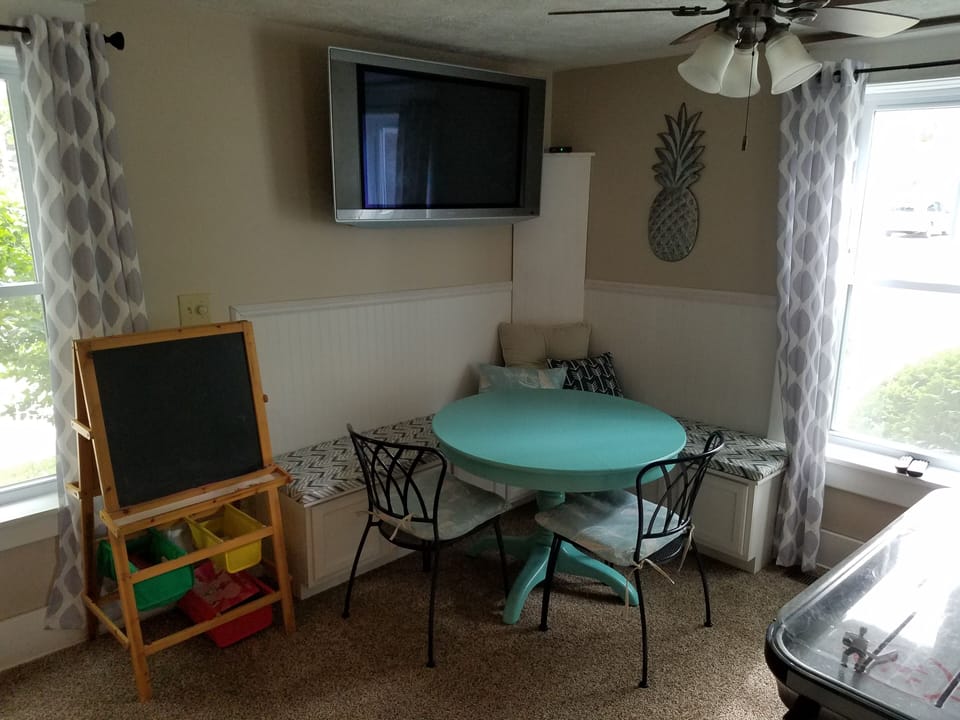 Corner bench area of the living room is fun for puzzles, games,  or cards.