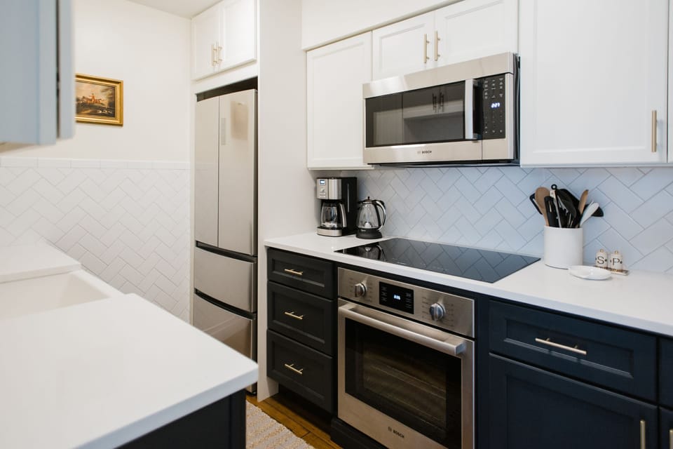 High-end stainless steel appliances, with a glass cooktop.