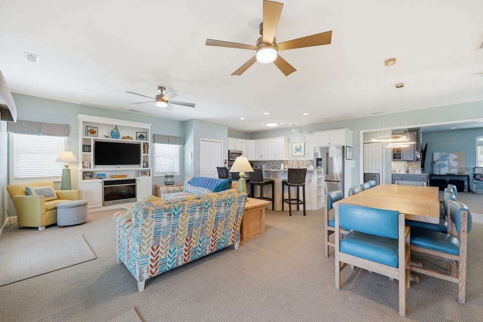 Step into your breezy coastal retreat, where soft blues and cheerful yellows create a bright, open space perfect for gathering, cooking, and unwinding together.