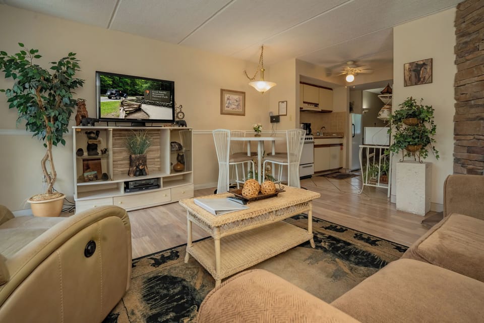 Relax in your warm, inviting living space with cozy seating, natural light, and a fully equipped kitchen just steps away—perfect for unwinding after a day of adventure.