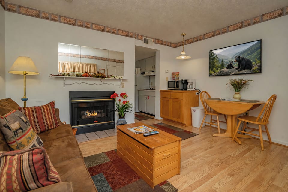 Curl up by the fireplace in this cozy living space, where warm wood tones and rustic touches create a welcoming retreat after your mountain adventures.
