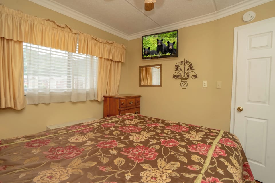 Relax in this cozy bedroom with warm natural light, soft linens, and a peaceful ambiance perfect for restful nights during your getaway.