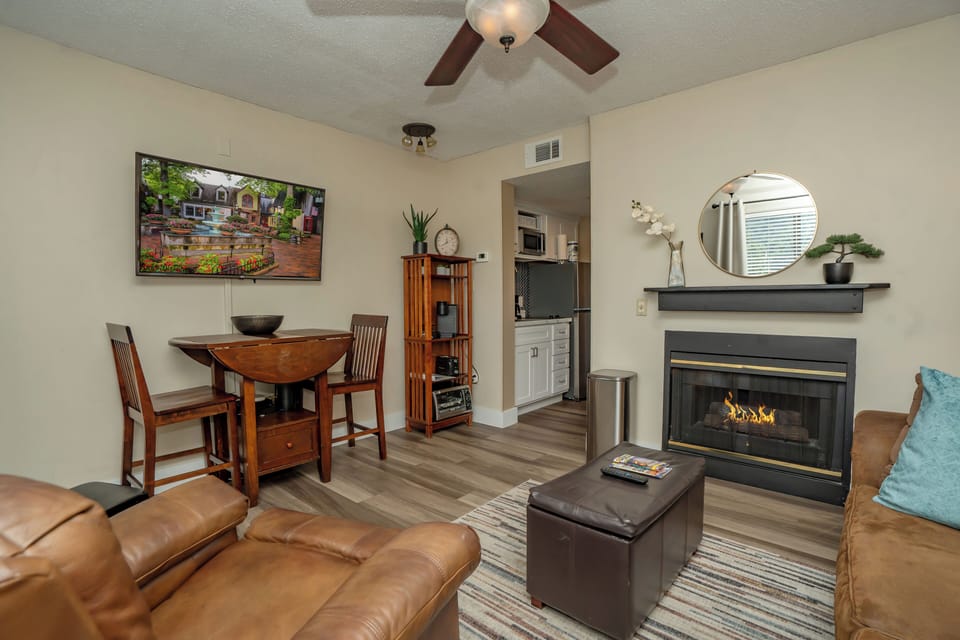 Relax in your open-concept living space with plush leather seating, a cozy fireplace, and modern comforts. Enjoy meals at the drop-leaf dining table while taking in the mountain view on the TV.