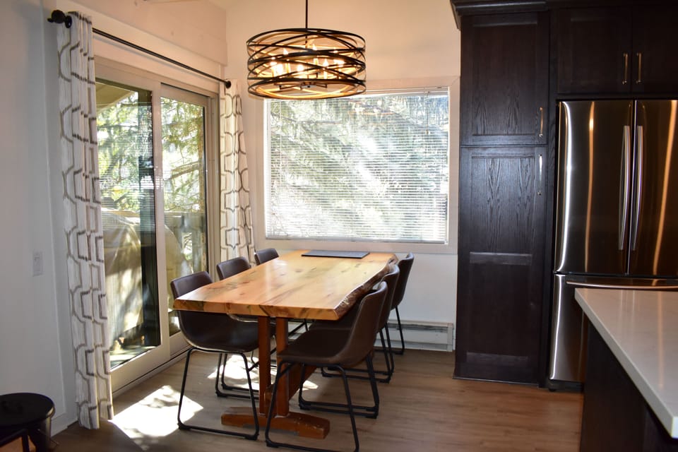 Beautiful dining area just off your balcony overlooking pine trees and a view to Mammoth Mountain