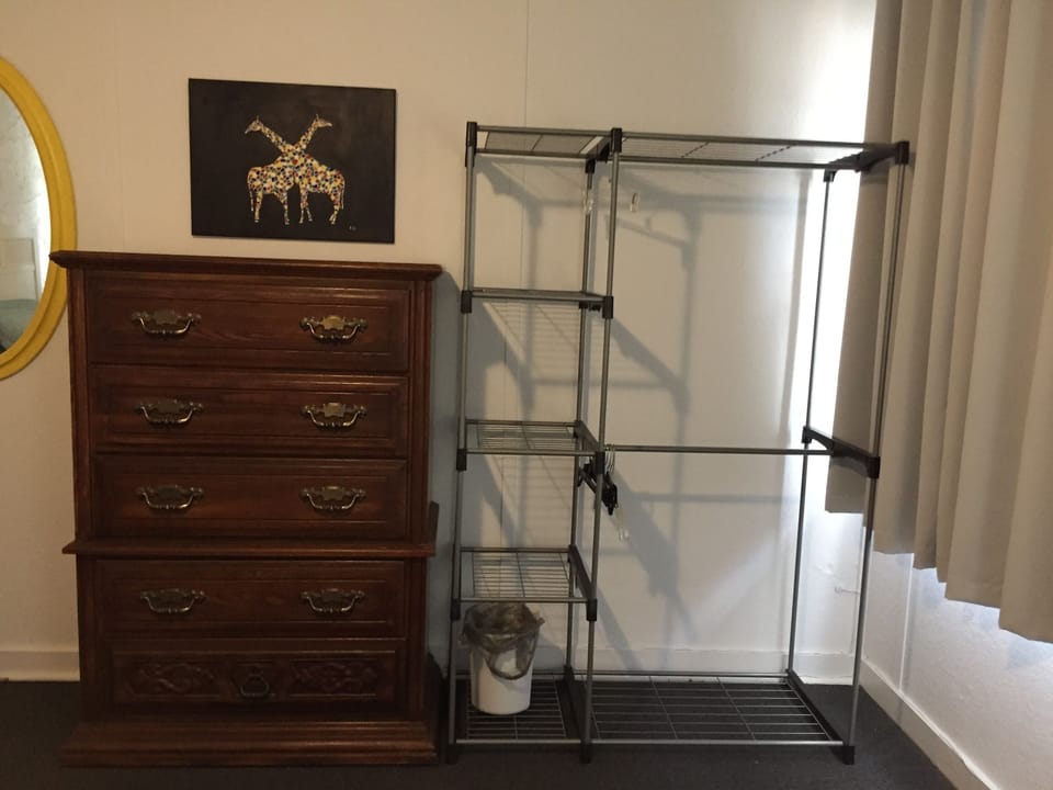 front bedroom dresser and clothes area