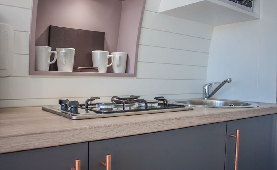 Kitchen with hob, fridge, sink and microwave