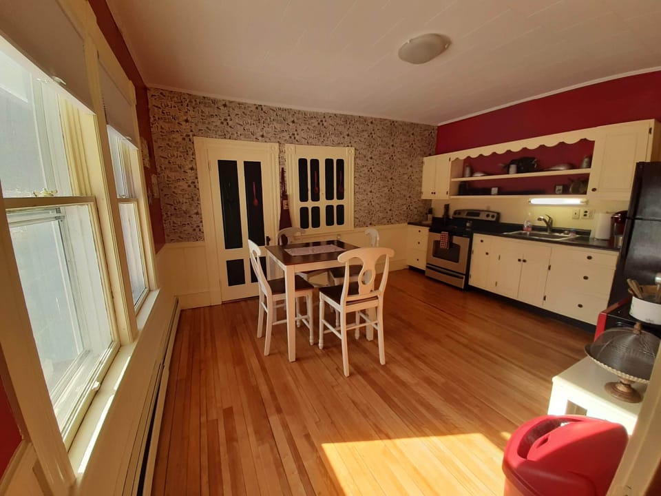 spacious kitchen, fully stocked with dishware, pots, pans, etc