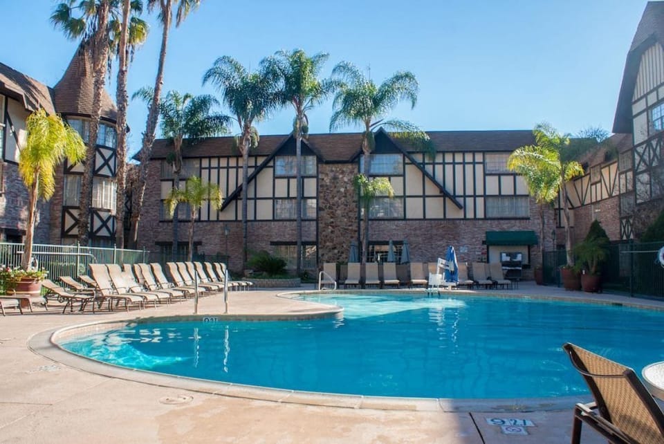 Dive into the sparkling resort pool surrounded by sun loungers.