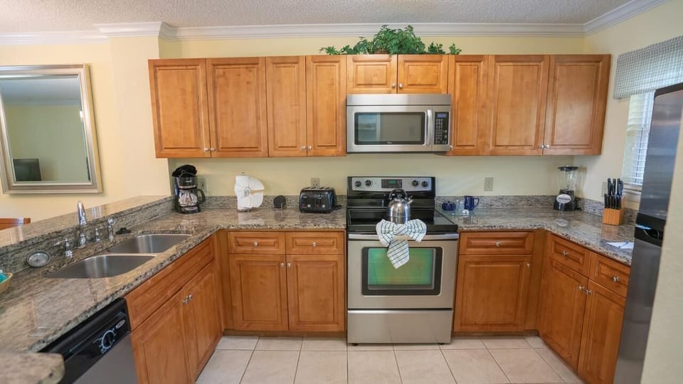 Cook with ease in a full kitchen with stainless appliances